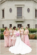 Bride and Bridesmaids wearing shades of pink floral looking at each other smiling at The Palladium