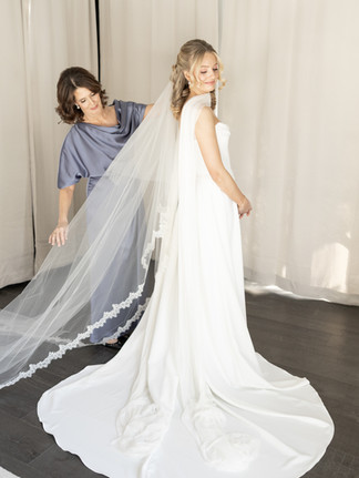 Brid and mother of the bride adjusting veil