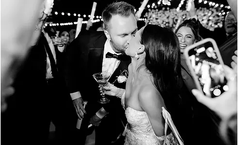 Black and white photo of bride and groom on the dance floor kissing at Indianapolis wedding reception