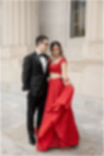 Bride in a red lehenga and groom in a black tuxedo for wedding photos at the Indianapolis Central Library
