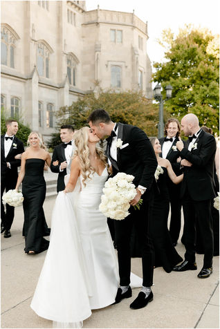 Bride and groom walking with wedding party outside Scottish Rite Cathedral 