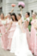 Bride and Bridesmaids cheering in mismatched pink