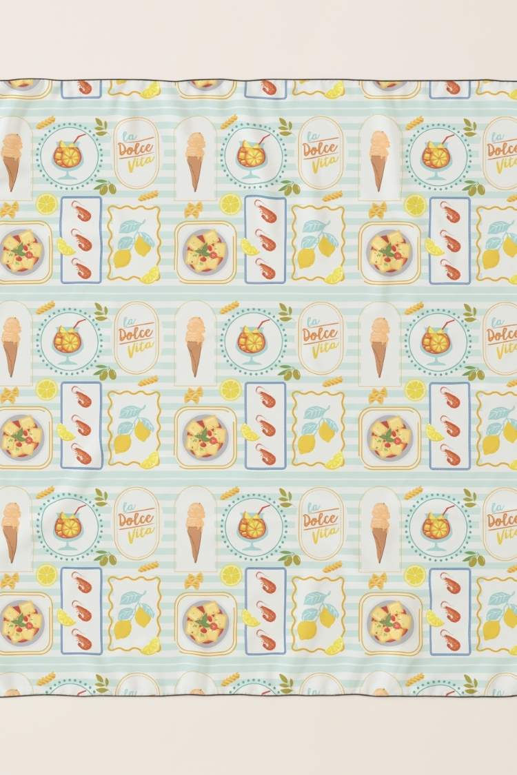 Patterned summer scarf with food illustrations: ice cream, cocktails, shrimp, Aperol, lemon slices. Text "La Dolce Vita" on a light blue striped background.