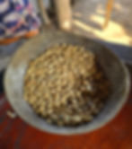 Close-up view of freshly roasted coffee beans in a burlap sack