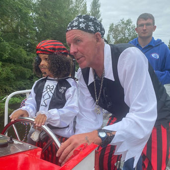 Pirate captain and child on boat ride