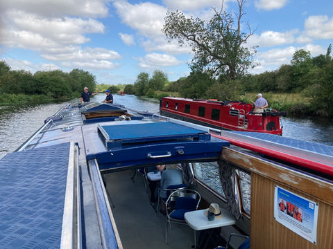 Canal boat cruise on sunny canal