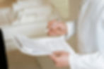Professional reviewing documents or compliance paperwork