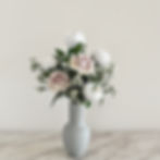 Faux rose arrangement with white peonies in grey vase