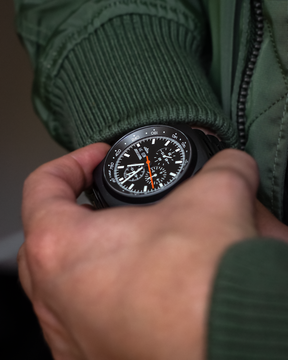 Eye-level view of a BYOP watch with leather strap on a wooden surface