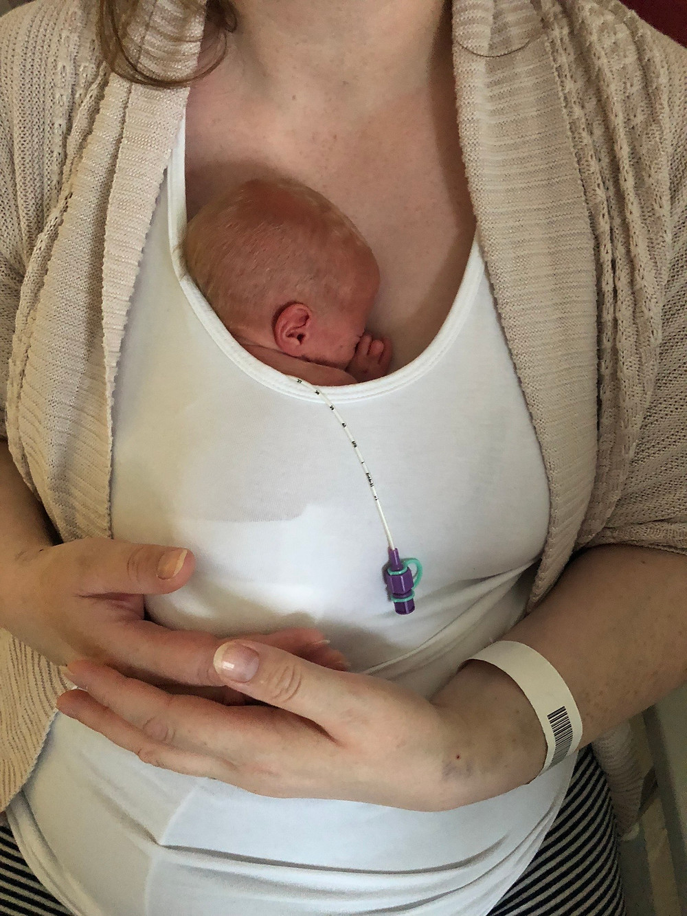 Lady holding her baby skin to skin
