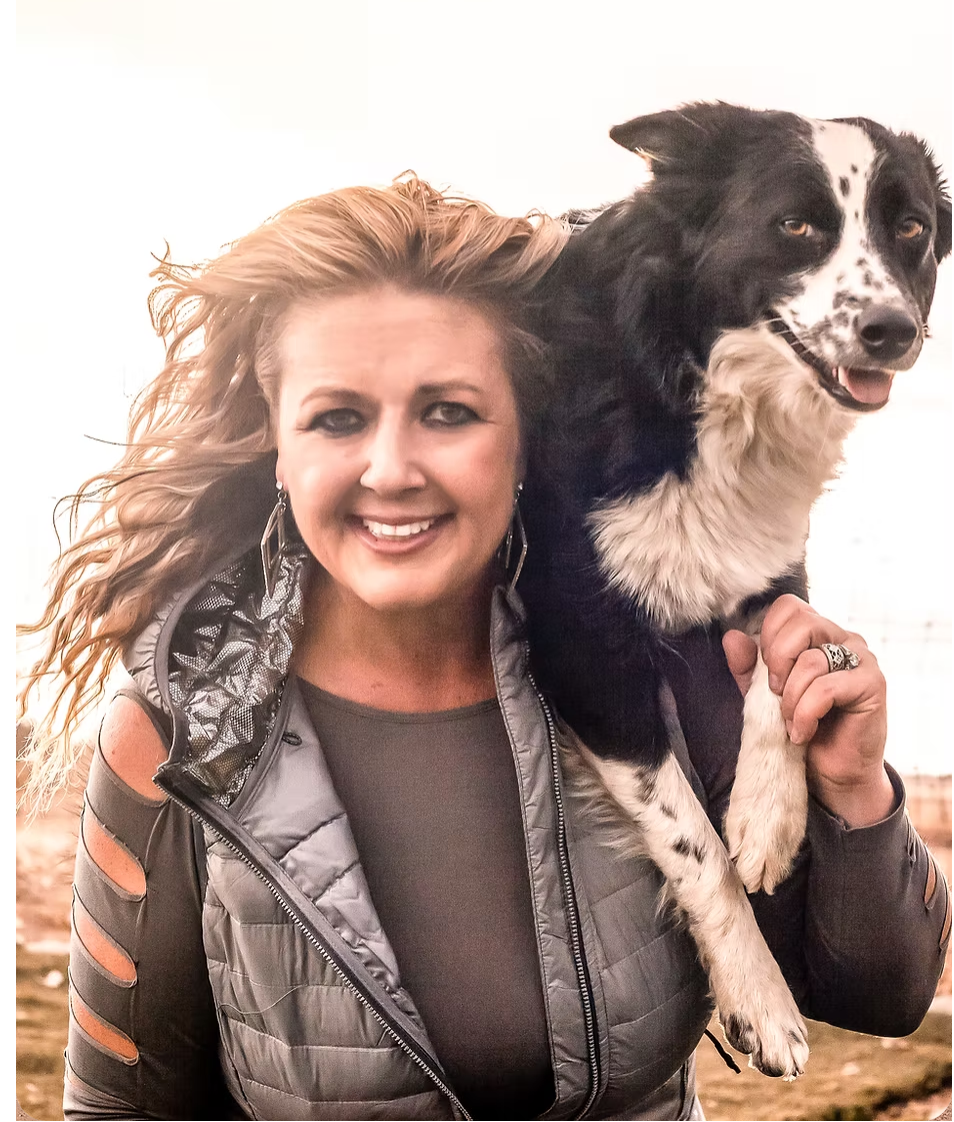 Kelly with a dog on her shoulder.