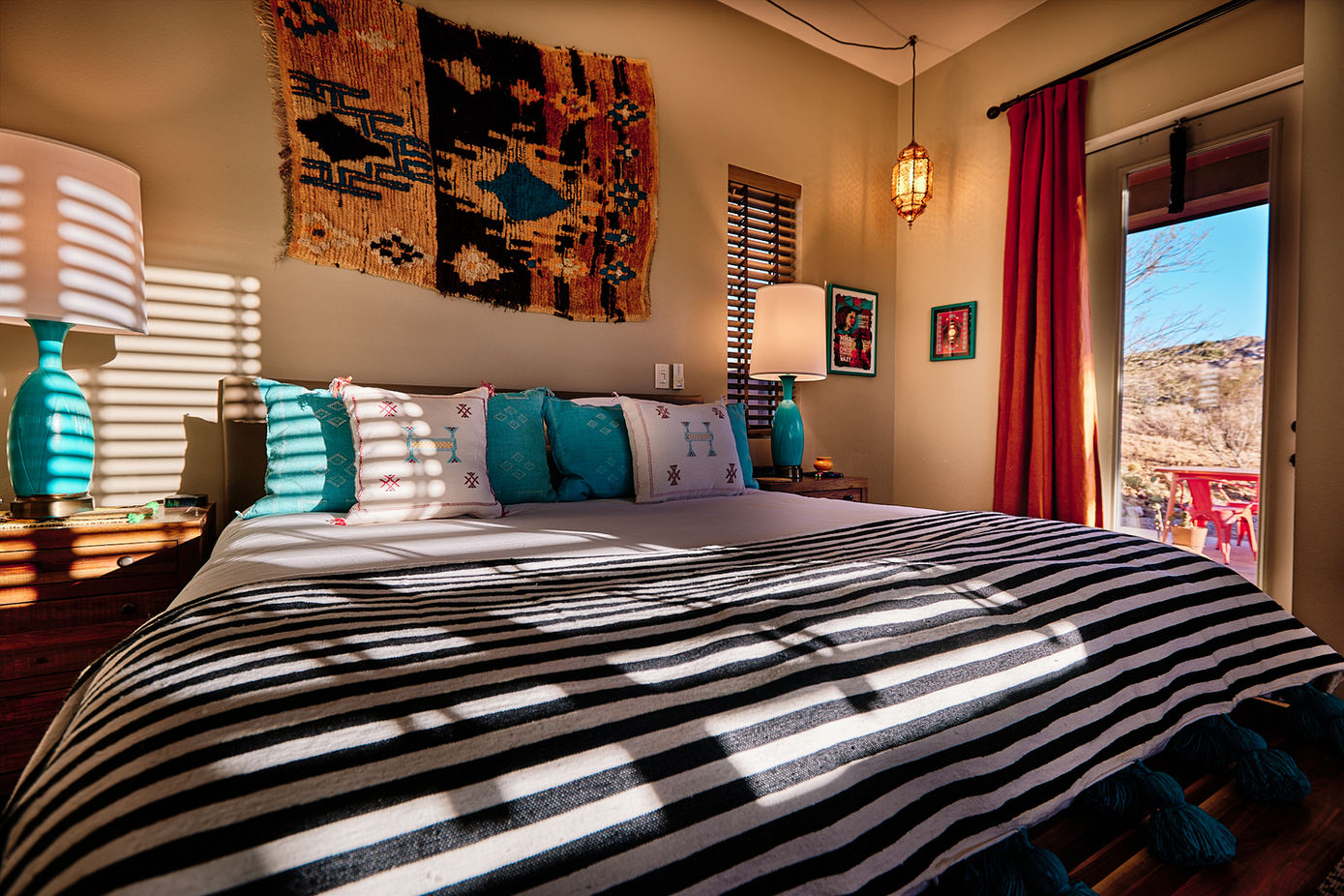 Lobo Luna bedroom at Sacred Sands with desert views and layered textiles