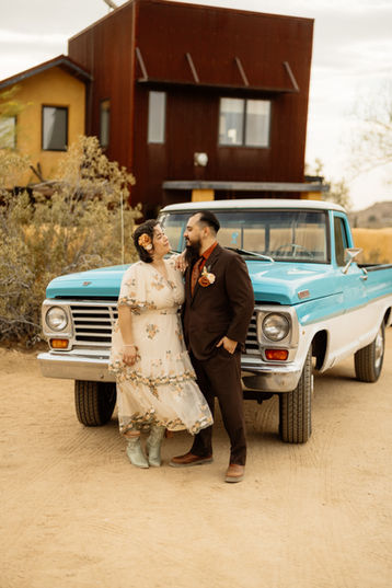 Boho bride and groom portrait with vintage truck at Sacred Sands
