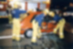 Firefighters use the jaws of life to pry a car door open to free a person at an incident, c. 1990s [Museum of Fire Collection]