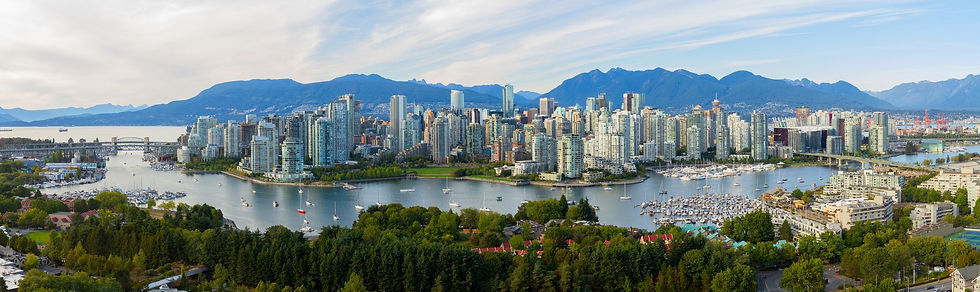 An image of Vancouver skyline featuring tall buildings on an island surrounded by water.