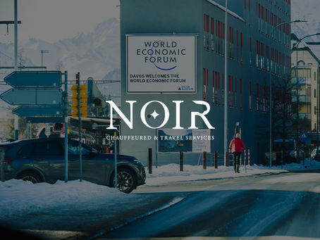 Winter city street in Davos featuring World Economic Forum signage and premium transportation vehicles supporting wef davos 2026 mobility operations.