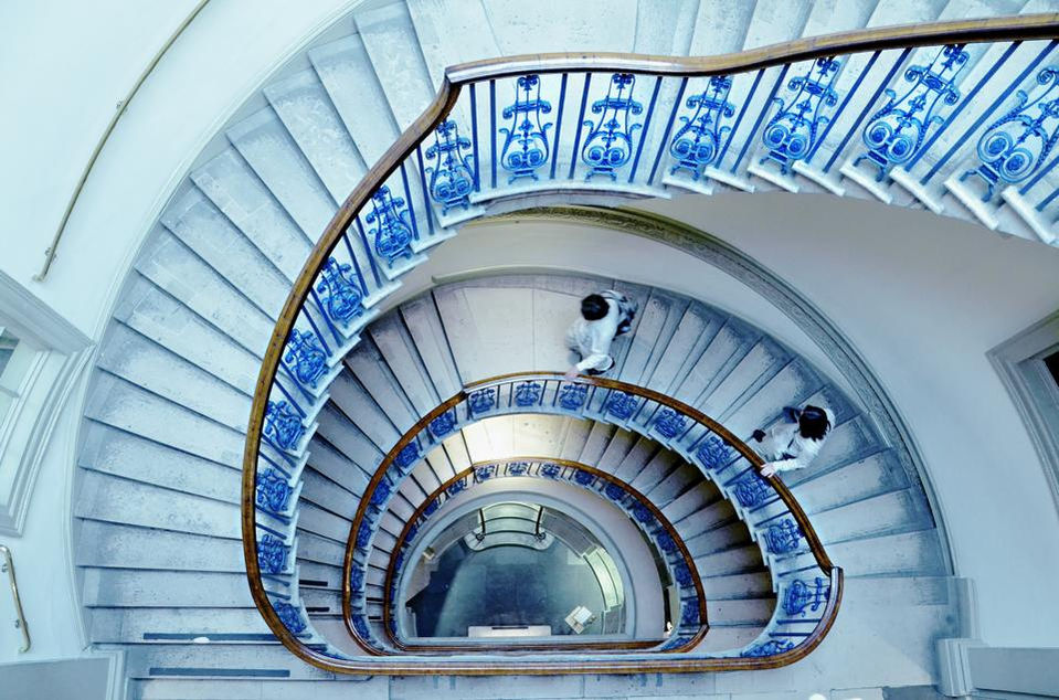 people walking down the spiral staircase of The Courtald Gallery, Somerset House, London.