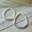 Thumbnail: Beaded bracelet with white round semi precious glass beads. White and black letter beads with the word Grandma. Beaded bracelet with white round semi precious glass beads. White and black letter beads with the word Grandma.