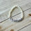 Thumbnail: Beaded bracelet with white round semi precious glass beads. White and black letter beads with the word Grandma.