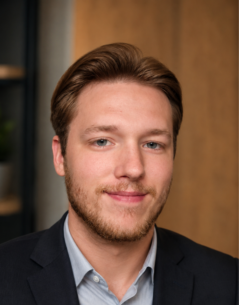 Professional headshot of a smiling man with a beard