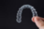 hand-holding-one-transparent-retainer-on-black-bac-2023-11-27-05-10-49-utc.jpg