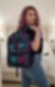 Chaos Kitten Emporium: Neon pink and teal graffiti 'Chaos' backpack shown on female model. Urban streetwear accessory
