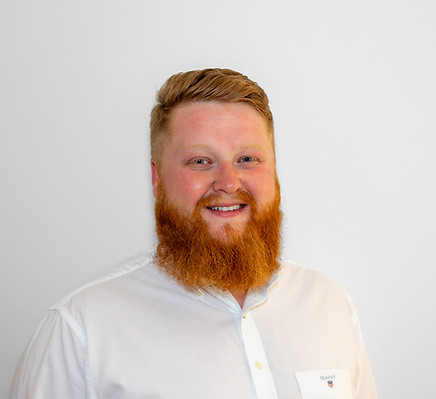 Headshot of a red haired man with a beard