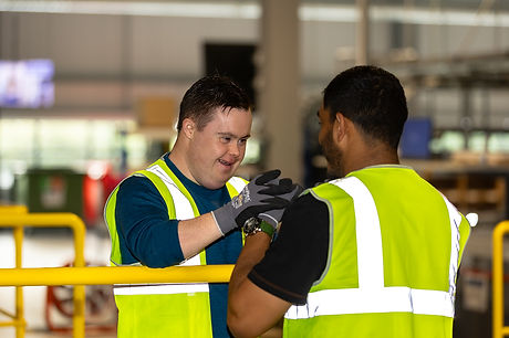 Two people enjoying working together, one has Down's syndrome