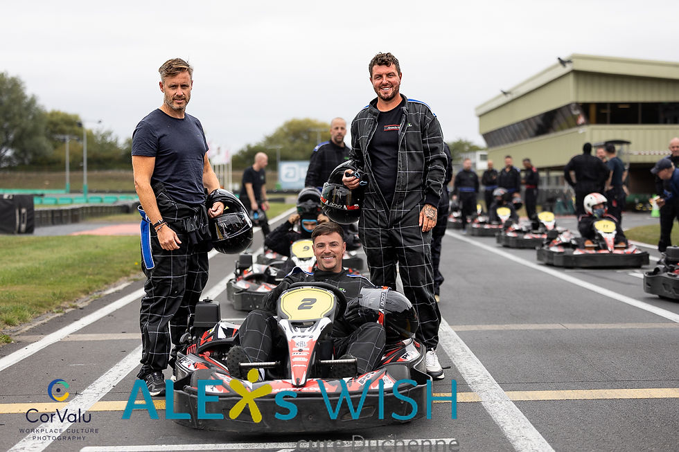 A team of go kart drivers posing.