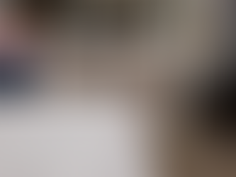 Person in pink sweater changes HVAC filter in utility room, swapping dirty filter for clean one. Background shows equipment and wiring.