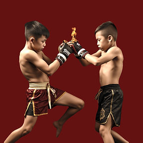 2 muay thai kids fighting in black backg
