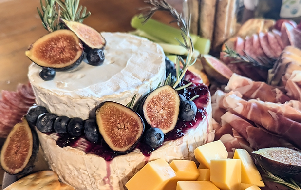Two Brie cheese rounds stacked to resemble a cake.