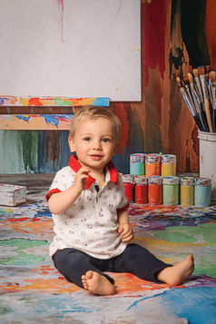 Séance enfant thème peinture, décor artistique avec pinceaux et toiles.