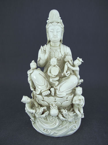 Blanc de Chine figure of Guanyin (Kwan Yin) 德化窑瓷塑牙白观音童子