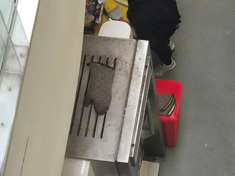 Dirty oven glove left on top of a metal fridge or appliance | Photo: Submitted