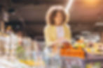 A woman holding a shopping list in a grocery store