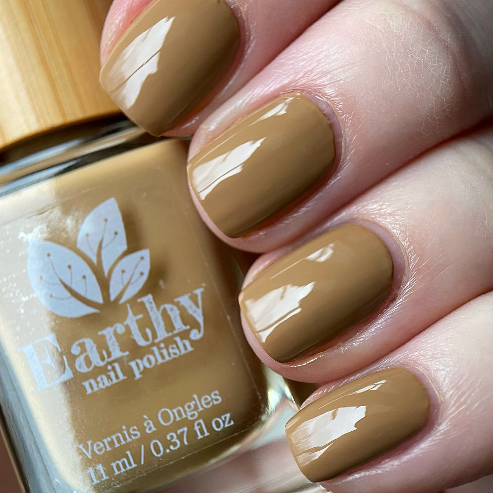 sandy shade of nail polish holding bottle