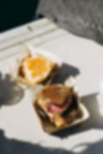 Two sandwiches in takeaway boxes, served for lunch.