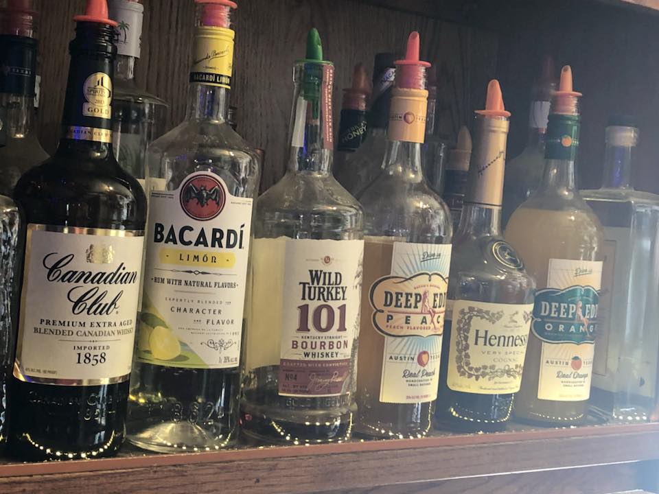 A tall whiskey and Coke on the bar