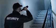 Guard Security guard is using flashlight in Dark Stairway