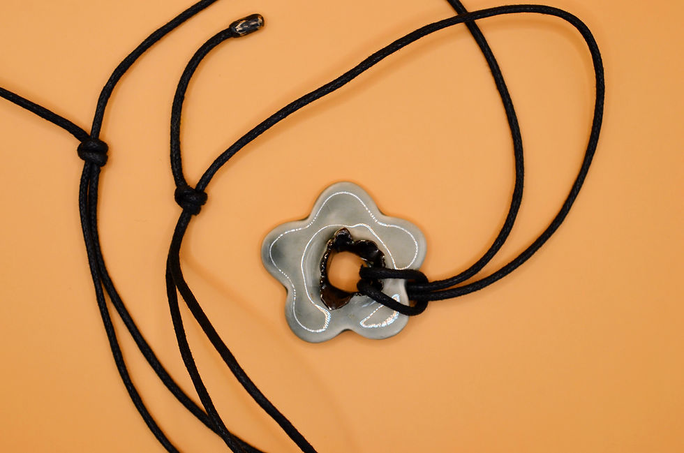 Thumbnail: Close-up of hand-painted grey ceramic flower pendant