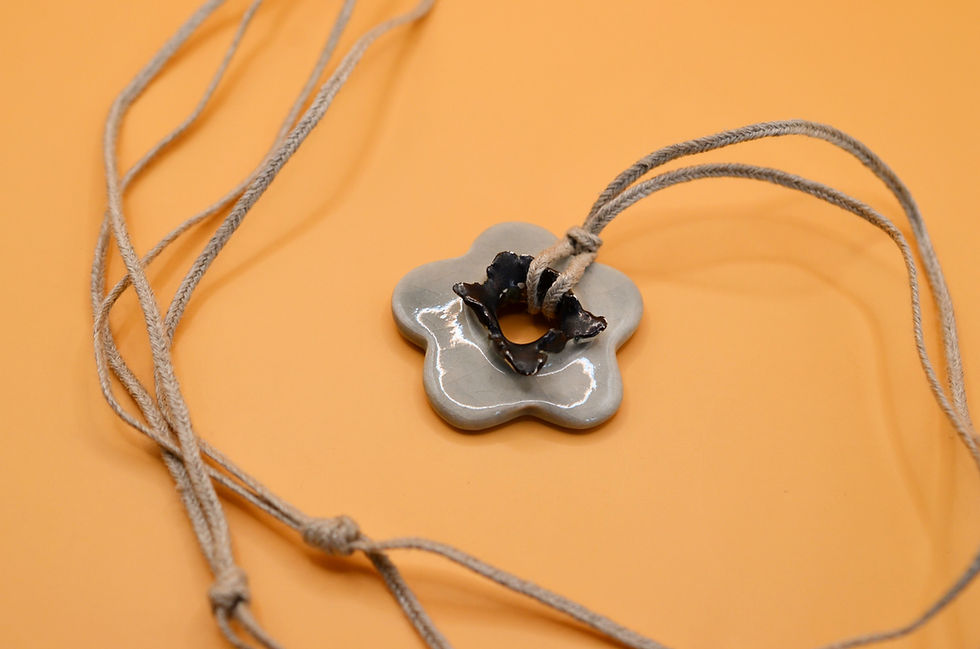 Thumbnail: Close-up of hand-painted grey ceramic flower pendant