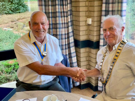 Outgoing President John Leonard handing over to Derek Stringer.