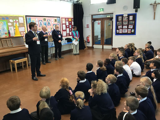 Pictured are Rotarians Derek Stringer, Andy Roberts, Bharti Patel and Rob Colwell talking to the children about the dictionaries.