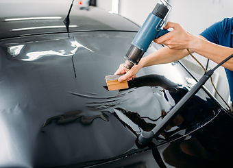 Heating and squeegeeing back window tint