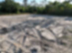 Lot clearing in Southwest Florida with visible skid steer tracks on freshly leveled sandy soil, prepared for construction or landscaping