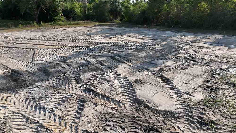 Smooth leveled land after clearing in Florida — soil surface with machinery tracks, showing professional land leveling results by PRIMUS Land Clearing.