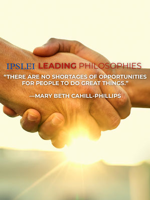 Shaking hands of two men in front of a sunset.