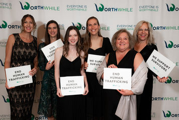 People holding 'end human trafficking' signs