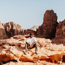 • The Wadi Rum desert landscape boasts mountains and dunes.
• Family exploring the desert terrain in Wadi Rum.
• Dune climbing in Wadi Rum, Jordan.
• Rocky Mountain formations rising above the desert floor.
• Wadi Rum offers a wide panoramic view of its desert landscape.
• A hot air balloon is flying over Wadi Rum at sunrise.
• Aerial view of desert dunes and mountains from above.
• Sun City Camp tents set against the Wadi Rum desert.
• The exterior of Sun City Camp is located in Wadi Rum.
• Evening light over the Wadi Rum desert.
• Night sky filled with stars above Wadi Rum camp.
• Campfire setup under the desert sky in Wadi Rum.
• Desert adventure vehicle driving through Wadi Rum.
• Scenic viewpoint overlooking the vast Wadi Rum valley.
• Sunset colors across the Wadi Rum landscape.